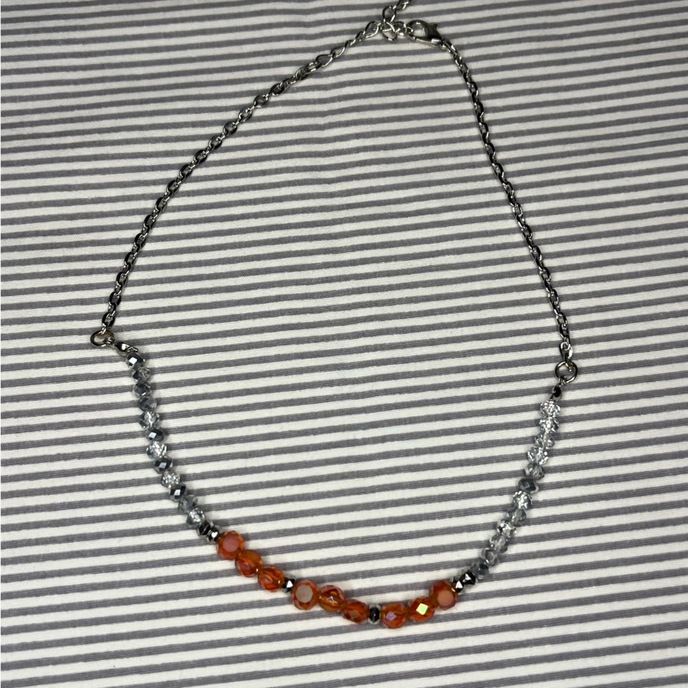 silver necklace with pink and clear center beads